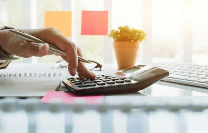 calculating-corporation-tax-1200 person calculating corporation tax