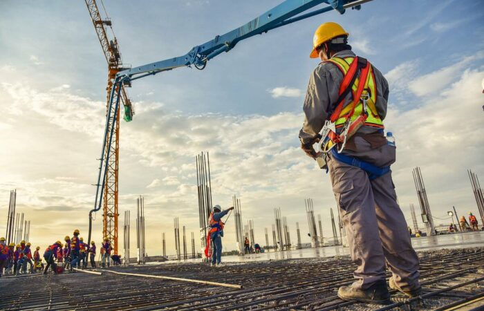 construction-workers-using-machinery-1200 person using machinery