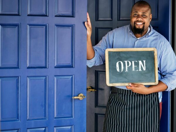 small-business-loan-1200 small business owner with open sign