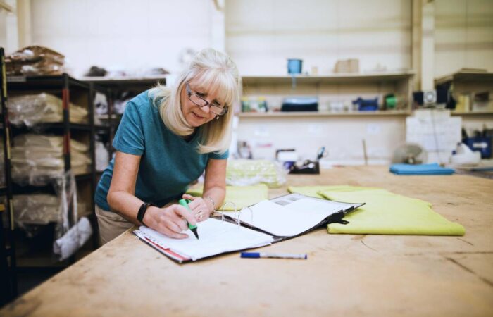 unsecured-business-equipment-loan-1200 lady writing in book