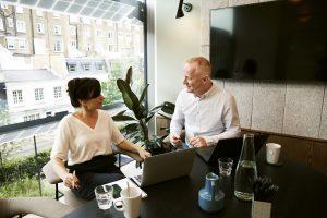 Two associates discussing the benefits and drawbacks of short term business loans